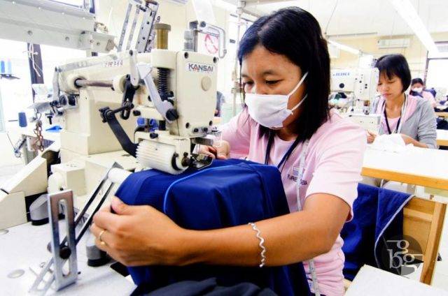 A lady working on a sewing machine