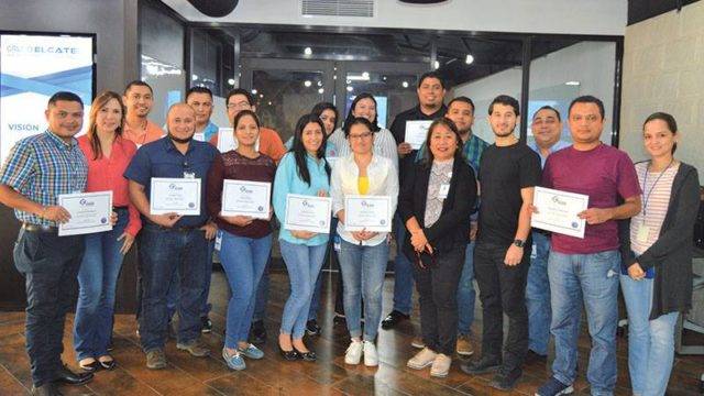 A group of trainees holding passing certificates