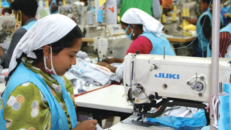 Woman working on a sewing machine in Epyllion factory in Bangladesh