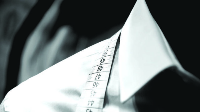 White plain shirt with inch tape over neckline