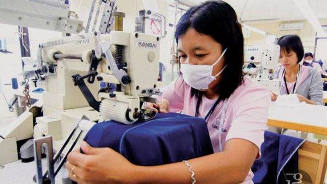 Female Apparel One Indonesia seamstress working on a sewing machine