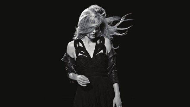 Model in black dress with dark background