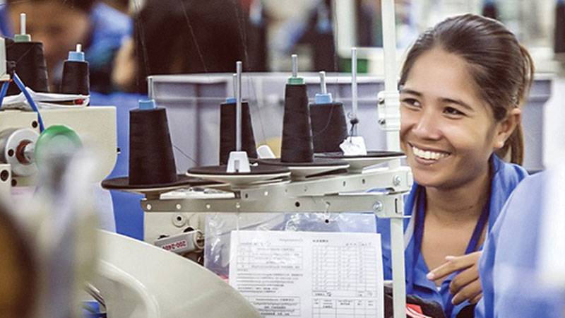 Woman worker working on a sewing machine in Sabrina factory, Taiwan