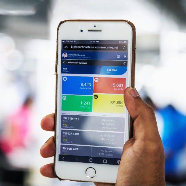 Hand holding a iPhone with Res.Q solution on screen in garment factory