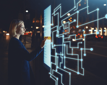 Female standing at big display with advanced innovative device with infographics design elements