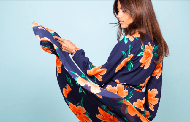A woman wearing blue dress with orange flowers